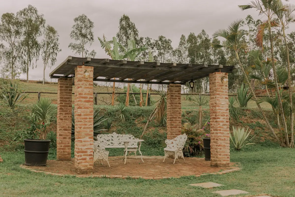 Pergola with seating in a green yard